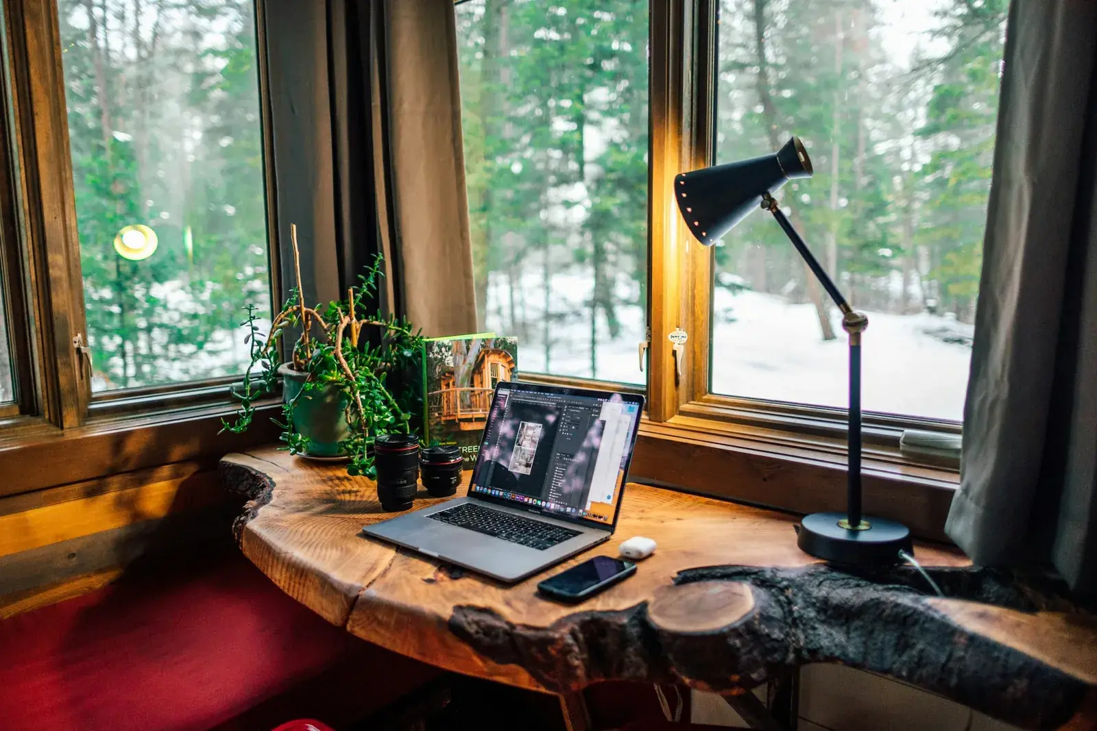A laptop beside a smartphone on a desk